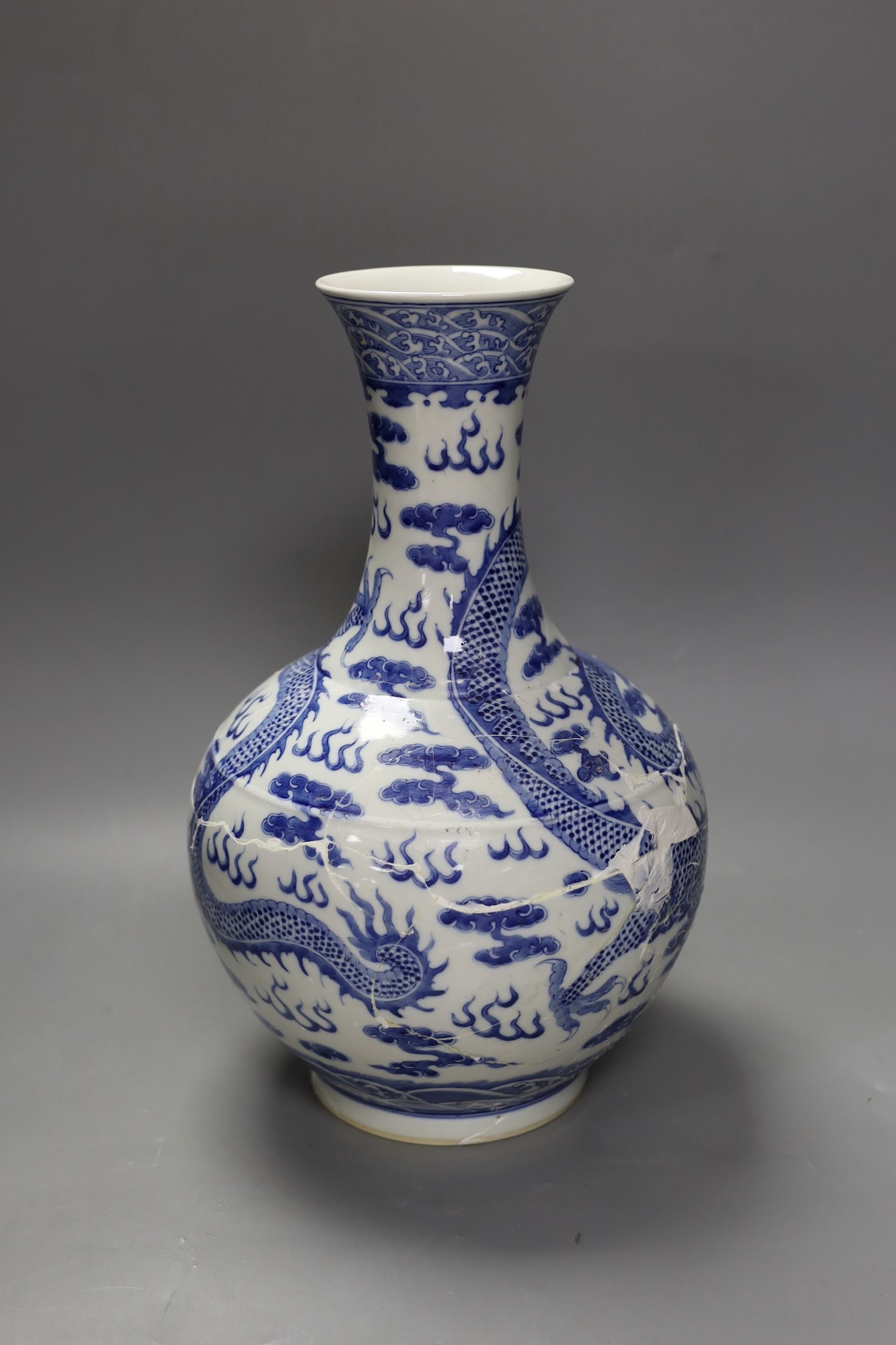 A large Chinese blue and white vase, damaged, 38cm